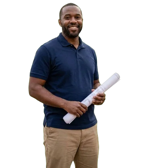 Smiling real estate investor in a navy polo holding rolled-up plans